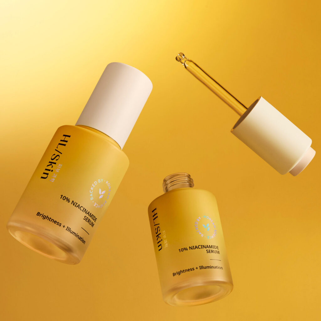 HL/Skin 10% Niacinamide Serum in goldener Produktinszenierung mit Pipette und geöffnetem Serumflakon